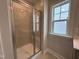 Close up of the glass enclosed shower with bench seating and a window at 1560 Bright Coral Trl, Wendell, NC 27591