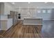 Modern kitchen with stainless steel appliances, a center island, and white cabinets at 157 Auburn Village Blvd, Raleigh, NC 27610