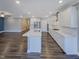 Open concept kitchen with white cabinets, stainless appliances and center island at 157 Auburn Village Blvd, Raleigh, NC 27610