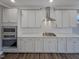 Beautiful kitchen with stainless steel appliances, white cabinets and subway tile backsplash at 157 Auburn Village Blvd, Raleigh, NC 27610