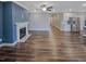 Open concept living room with fireplace and hardwood flooring overlooking kitchen at 157 Auburn Village Blvd, Raleigh, NC 27610