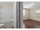 View of a full bathroom and bedroom with wood floors at 158 Torain St, Hillsborough, NC 27278
