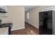 Cozy kitchen featuring a modern black refrigerator, stove, and bright window at 158 Torain St, Hillsborough, NC 27278
