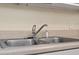 Close-up of a stainless steel kitchen sink with a chrome faucet and sprayer at 158 Torain St, Hillsborough, NC 27278