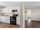 Efficient kitchen layout with white cabinets and open access to other rooms at 158 Torain St, Hillsborough, NC 27278