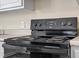 Close-up of a black electric stove with a digital display and knobs at 158 Torain St, Hillsborough, NC 27278