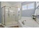 Bright bathroom featuring a luxurious soaking tub, glass-enclosed shower, and stylish fixtures and finishes at 1705 Yates Pond Way, Raleigh, NC 27606