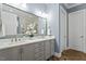 Bright bathroom with double vanity, herringbone floors, large mirror, and a separate water closet at 1705 Yates Pond Way, Raleigh, NC 27606