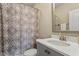 Bathroom featuring a vanity with a sink, toilet, and a shower with patterned shower curtain at 1705 Yates Pond Way, Raleigh, NC 27606