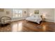 Bright bedroom with hardwood floors, a large window, and neutral decor, creating a serene atmosphere at 1705 Yates Pond Way, Raleigh, NC 27606