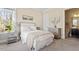 Cozy bedroom with plush carpeting, neutral tones, and plenty of natural light, creating a relaxing retreat at 1705 Yates Pond Way, Raleigh, NC 27606