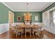 Bright dining room featuring hardwood floors, wainscoting, and a chandelier at 1705 Yates Pond Way, Raleigh, NC 27606
