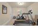 Home exercise room featuring a treadmill, stationary bike, and workout accessories for convenient fitness at 1705 Yates Pond Way, Raleigh, NC 27606