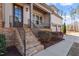 Inviting front porch with stone stairs, metal railings, and space for seating at 1705 Yates Pond Way, Raleigh, NC 27606