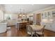 Modern kitchen flows into an eat-in area with large windows and features a granite countertop island at 1705 Yates Pond Way, Raleigh, NC 27606