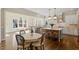 Open concept kitchen features granite countertops, a tile backsplash, a breakfast bar, and an eat-in area at 1705 Yates Pond Way, Raleigh, NC 27606