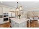 Gourmet kitchen with a large island, stainless steel appliances, and a seamless open-concept layout at 1705 Yates Pond Way, Raleigh, NC 27606