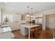 Modern kitchen features stainless steel appliances, a large island, tile backsplash, and abundant natural light at 1705 Yates Pond Way, Raleigh, NC 27606