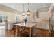 Bright, eat-in kitchen featuring granite countertops, white cabinets, stainless steel appliances, and a large island at 1705 Yates Pond Way, Raleigh, NC 27606