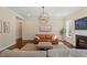 Charming living room featuring a decorative fireplace, chandelier, neutral color palette, and natural light at 1705 Yates Pond Way, Raleigh, NC 27606
