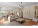Open concept living room showcasing an open floor plan connecting the kitchen and fireplace at 1705 Yates Pond Way, Raleigh, NC 27606