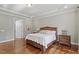 Comfortable main bedroom with hardwood floors, tray ceilings, and ample space for a king-size bed and dressers at 1705 Yates Pond Way, Raleigh, NC 27606