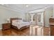 Spacious main bedroom features hardwood floors, tray ceilings, and bay windows overlooking a private backyard at 1705 Yates Pond Way, Raleigh, NC 27606