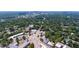 Aerial view of neighborhood with lush greenery and a downtown city skyline in the distance at 202 Duncan St, Raleigh, NC 27608