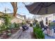 Private backyard with a brick patio, string lights, and lush landscaping, perfect for entertaining at 202 Duncan St, Raleigh, NC 27608