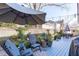 Backyard deck features a sitting area, privacy fence, plants, and string lights at 202 Duncan St, Raleigh, NC 27608
