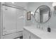 Bright bathroom features a shower and tub combo, vanity with mirror, and tile flooring at 202 Duncan St, Raleigh, NC 27608