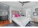 Stylish bedroom with a patterned headboard, dark furniture, ceiling fan and hardwood floors at 202 Duncan St, Raleigh, NC 27608