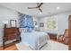 This comfortable bedroom offers a ceiling fan and a large window providing natural light at 202 Duncan St, Raleigh, NC 27608
