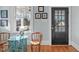 Stylish foyer with a unique table, wooden chair, and natural light from a large window at 202 Duncan St, Raleigh, NC 27608