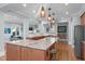 Gourmet kitchen with a large island, granite countertops, stainless steel appliances, and custom lighting at 202 Duncan St, Raleigh, NC 27608