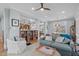 Open-concept living area with hardwood floors, built-in bookshelves, and seamless flow to kitchen and dining at 202 Duncan St, Raleigh, NC 27608
