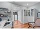 Bright home office features hardwood floors, a built-in desk, shelving, and custom display cabinets at 202 Duncan St, Raleigh, NC 27608