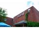 Close-up of the brick NoFo retail building with ivy growing on the side at 202 Duncan St, Raleigh, NC 27608