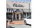 Exterior of the Charlottes retail storefront features a black and white awning and potted plants at 202 Duncan St, Raleigh, NC 27608
