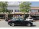 A street view of a shopping center with various shops including Jeni's Ice Cream at 202 Duncan St, Raleigh, NC 27608