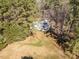Aerial view of a home nestled among lush green trees, offering privacy and a serene natural setting at 205 Old Greensboro Rd, Chapel Hill, NC 27516