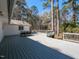 A spacious deck offers outdoor dining and relaxation with a view of the wooded backyard at 205 Old Greensboro Rd, Chapel Hill, NC 27516