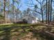 Backyard showcasing home with deck and expansive greenery at 205 Old Greensboro Rd, Chapel Hill, NC 27516