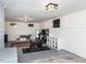Finished basement with workout equipment, TV, storage, and neutral-toned walls and flooring at 205 Old Greensboro Rd, Chapel Hill, NC 27516