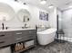 Bright, elegant bathroom featuring a modern double vanity, free-standing tub, and tiled glass shower at 205 Old Greensboro Rd, Chapel Hill, NC 27516