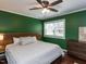 This bedroom offers a modern ceiling fan, a natural wood headboard and dresser with great natural light at 205 Old Greensboro Rd, Chapel Hill, NC 27516
