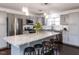 Modern kitchen with gray cabinets, stainless steel appliances, granite counters, and an island with seating at 205 Old Greensboro Rd, Chapel Hill, NC 27516