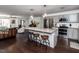 Bright open floor plan featuring the living room, kitchen with island, and stainless steel appliances at 205 Old Greensboro Rd, Chapel Hill, NC 27516