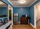 A cozy kitchenette with a stainless steel refrigerator, wooden cabinet, and beautiful hardwood flooring at 205 Old Greensboro Rd, Chapel Hill, NC 27516