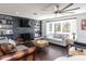 Bright living room with hardwood floors, a fireplace, built-in shelving, and large windows at 205 Old Greensboro Rd, Chapel Hill, NC 27516
